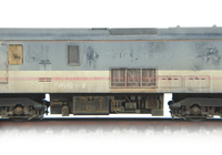 A picture of Close up of Scrapline loco showing the heavily faded body and boarded up windows.