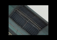 A picture of Close up of etched grills with pipes underneath the mesh