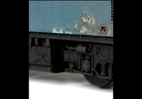 A picture of 26018 Conversion to disc headcode version representing a loco in it's last days on the scrapline. Full respray into correct faded shades, renumbered, disc catches, special effect of paint peeling and rust patches, broken and boarded over windows, tapered steps with leaf spring bogies, brass oval buffers, straight framed side windows, speedo cable, removed boiler control access hatch, wire nose handrails, no rubber window surrounds, side body windows made flush and detailed buffer beam at both ends.