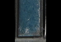 A picture of Close up of paint peeling on door showing the bare metal coming through.