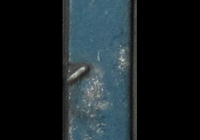 A picture of Close up of paint peeling on door showing the bare metal coming through.