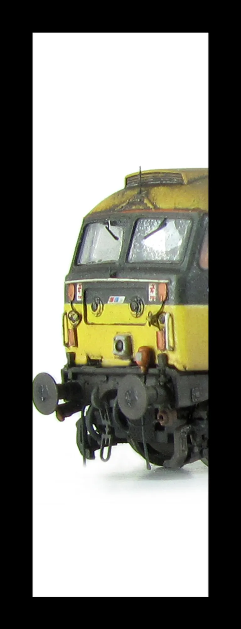 47706 showing a partial respray to Scotrail blue stripe with NSE branding in a very dilapidated state with special effects of fading and paint flaking. Other details include: detailed buffer beam at one end, body lowered, etched fan and grill, moulded nos