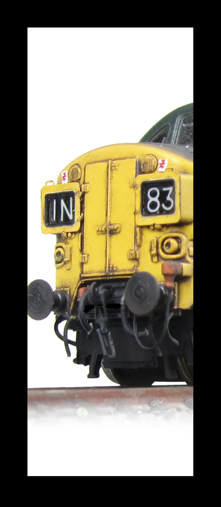 D6754 Double detailed buffer beam at one end.  Renumbered, Etched headcode surrounds and air horn covers.  Faded body.  Bogie modification to reduce gap between top of bogies and body. Change of headcodes and modified so that they sit flusher to the front