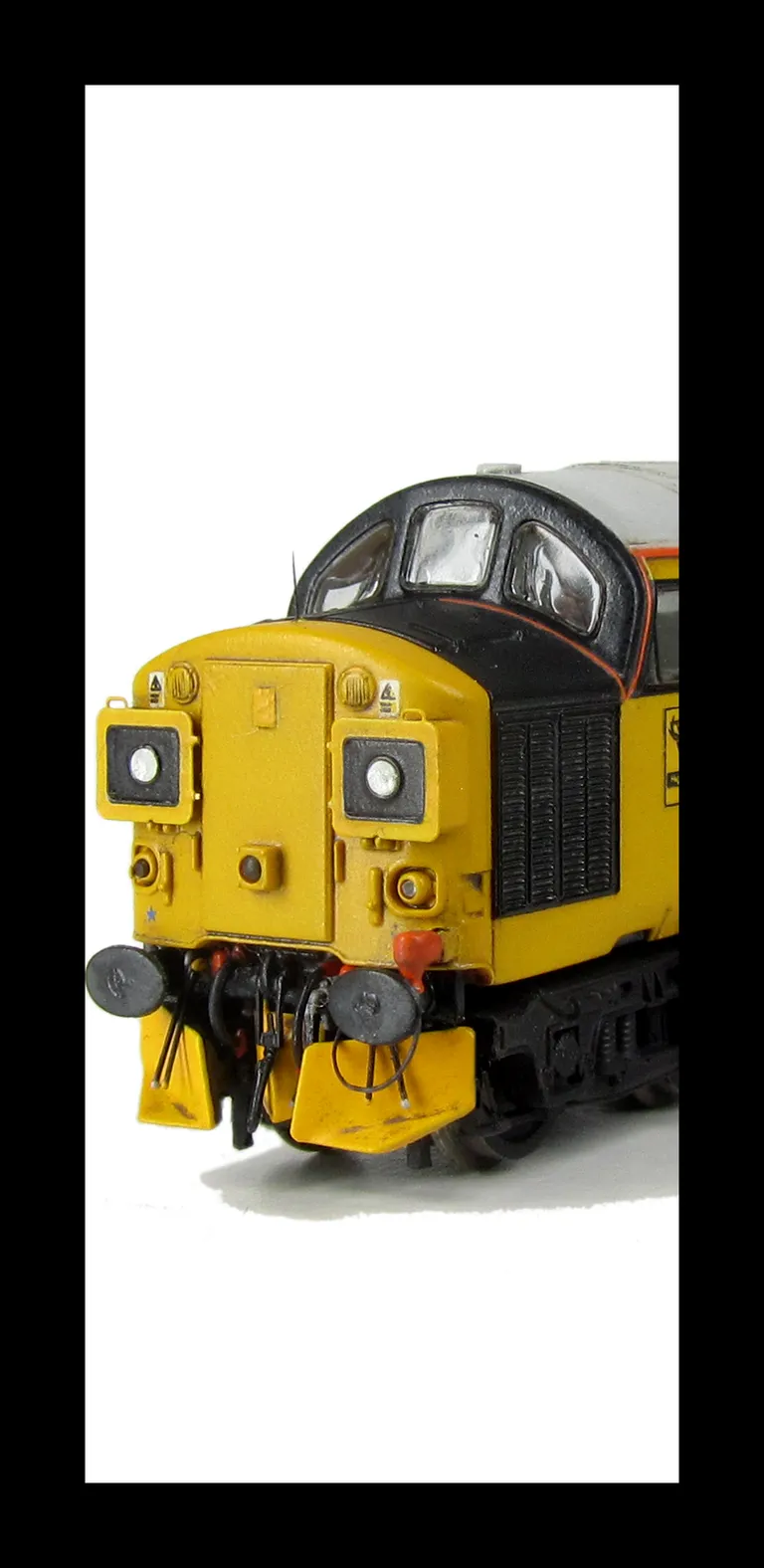 37025 with plated over boiler port and steps with respray of blue and black with cantrail added. Other details include: nose catch, snowploughs, etched nameplates, bogie modification to reduce gap between body and bogies, driver and second man, finer aeri