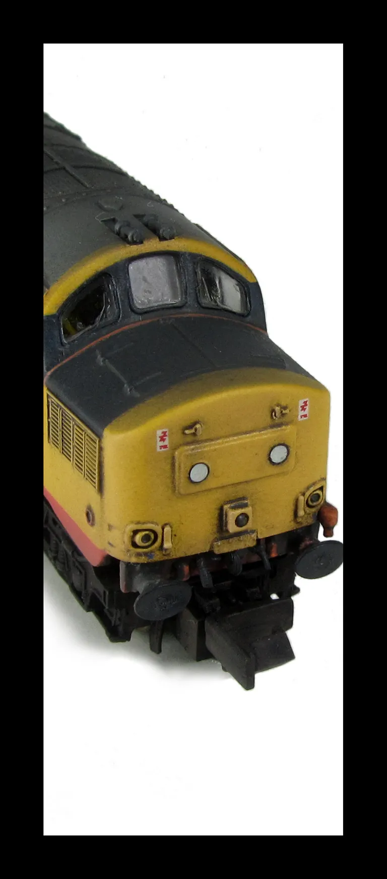 37160 with modification of nose ends to extra cutaway version and full respray to Railfreight red stripe.Other details include: boiler access panel and steps plated over, bogie modification to reduce gap between body and bogies, nose catches, snowploughs,