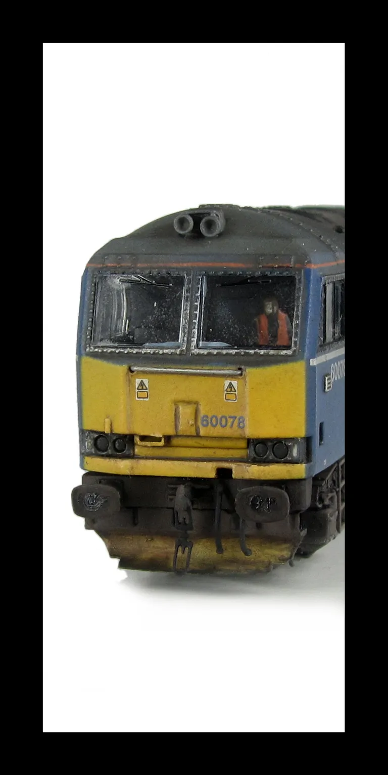 60078 Faded Mainline livery, detailed buffer beam at one end, body lowered, EWS sticker added along with yellow snowploughs, driver and paint flaking on window surrounds.