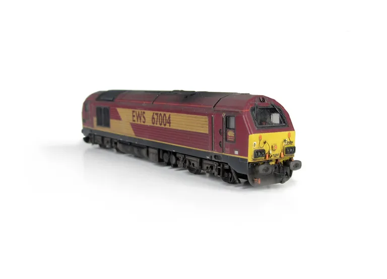 67004 with detailed buffer beam at one end and semi detailed at coupler end, moulded jumper cables replaced with wire versions, renumbered, etched nameplates and driver fitted.