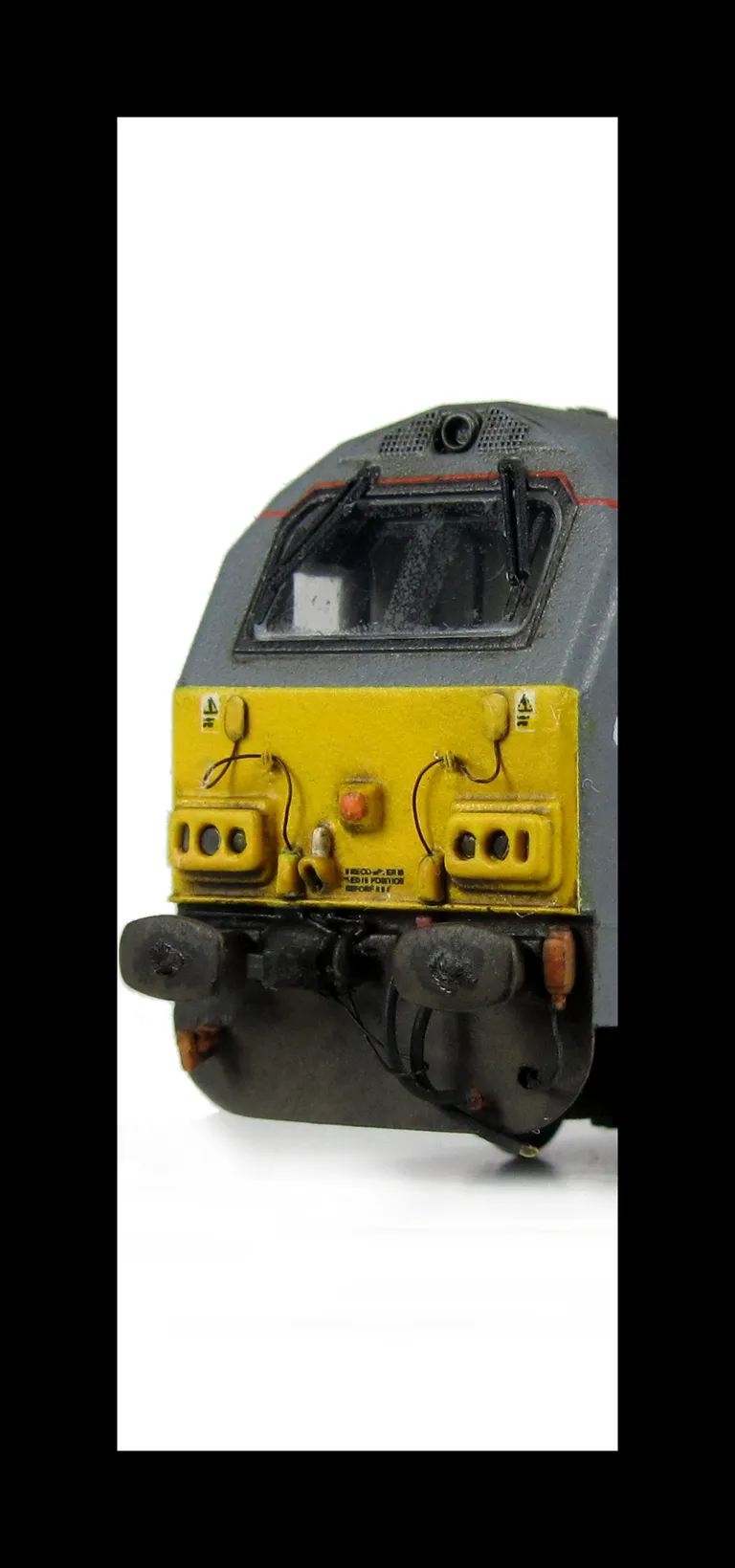 67014 with detailed buffer beam at one end and semi detailed at coupler end, moulded jumper cables replaced with wire versions, renumbered, etched nameplates and driver fitted.