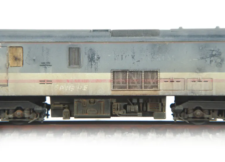 Close up of Scrapline loco showing the heavily faded body and boarded up windows.