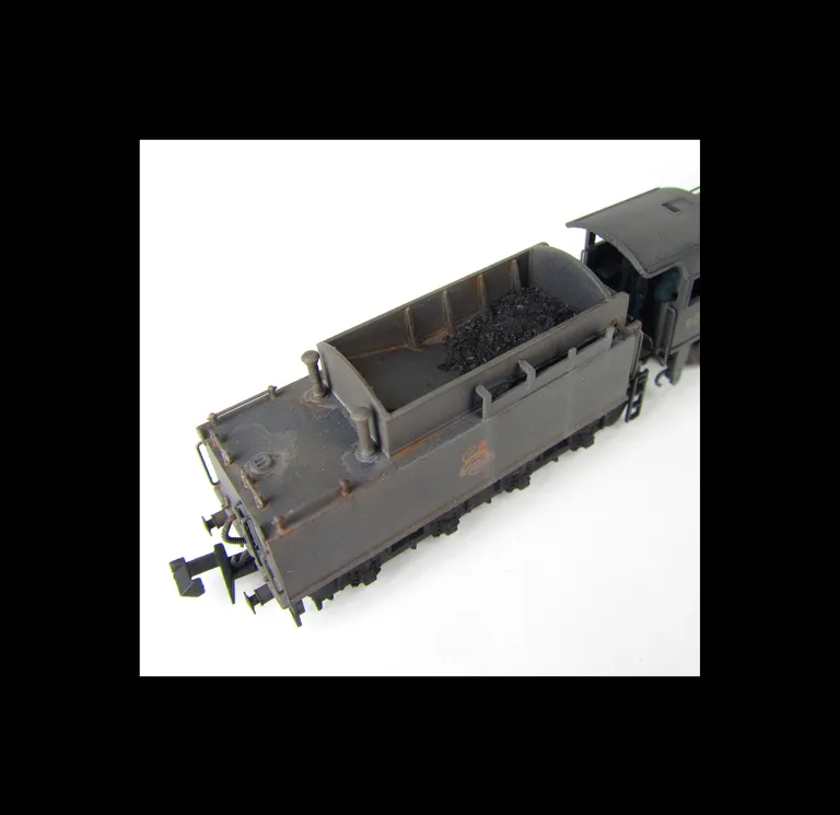 WD Austerity 90354 weathered to represent the last days of steam. Added details include: renumbered, molded coal replaced with real coal, loco crew added, fire irons, detailed buffer beam at one end and painted cab interior.