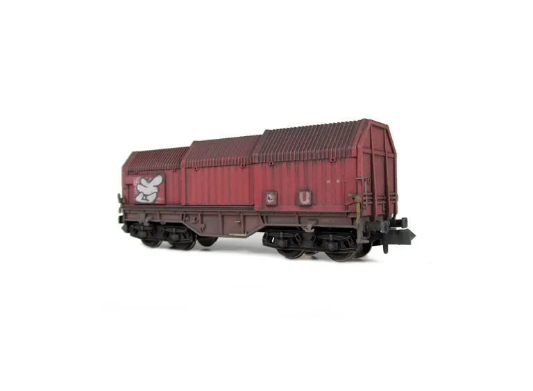 Wagon with faded paintwork and added graffiti.