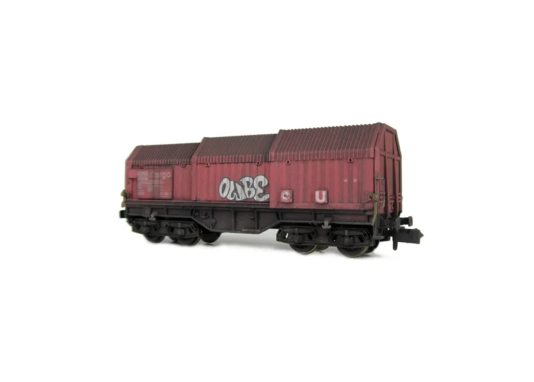 Wagon with faded paintwork and added graffiti.