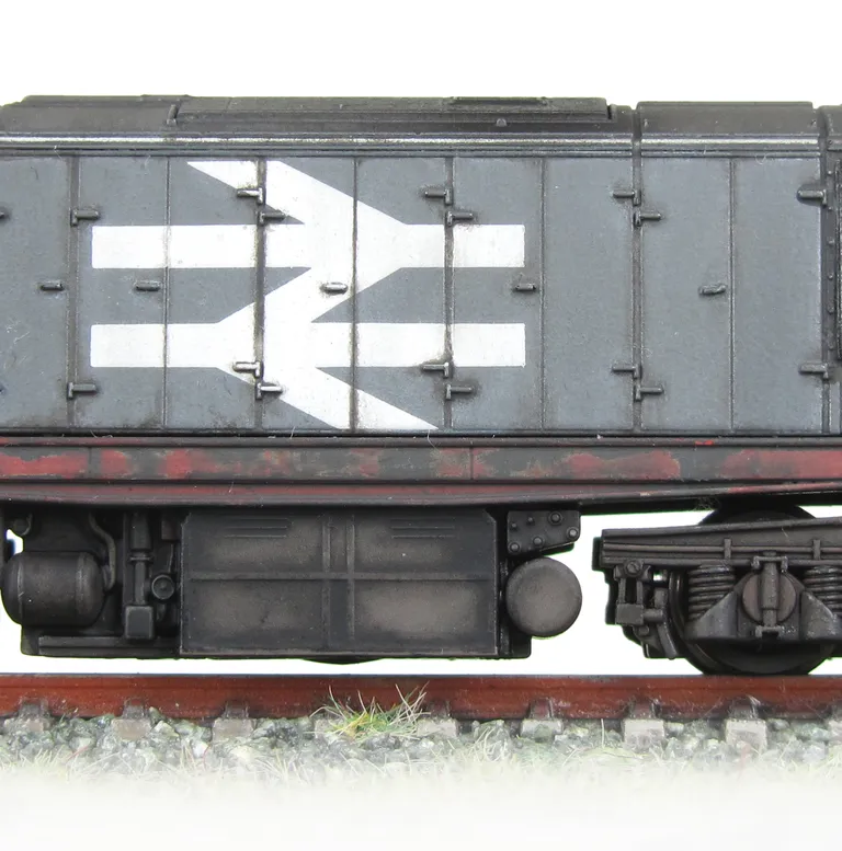 58029 showing the dappled fading effect on the panels and paint peeling on the underframe.