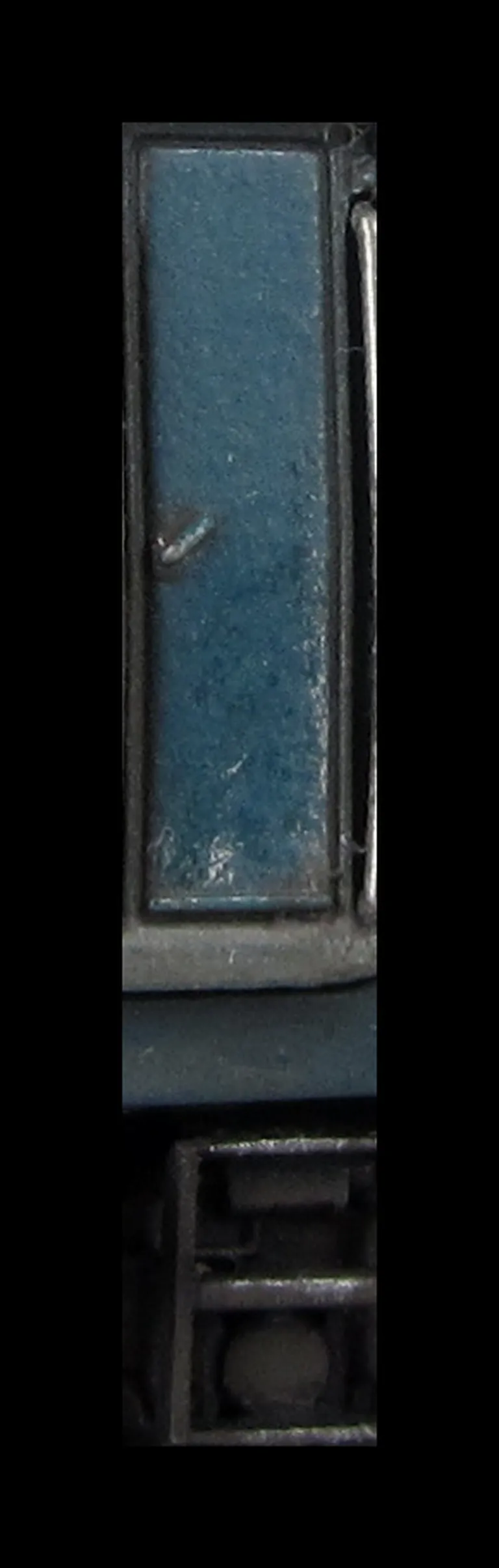 Close up of paint peeling on door showing the bare metal coming through.