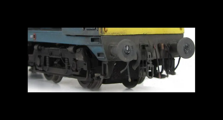 Close up of detailed buffer beam, squared off buffer and speedo cable on bogies.