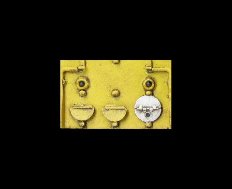 Close up of added fine discs and holes filled with respray of yellow.